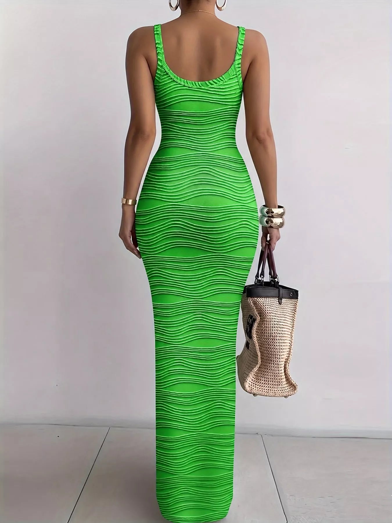 Bright green sleeveless bodycon maxi dress with wavy textured fabric viewed from behind