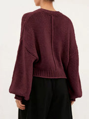 Back view of a burgundy oversized chunky knit sweater with balloon sleeves