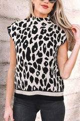 Close front view of the black and cream leopard print high neck sweater with cap sleeves, outdoors.