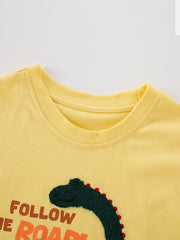 Close-up of the yellow ribbed round neckline and dinosaur head graphic on a children's T-shirt