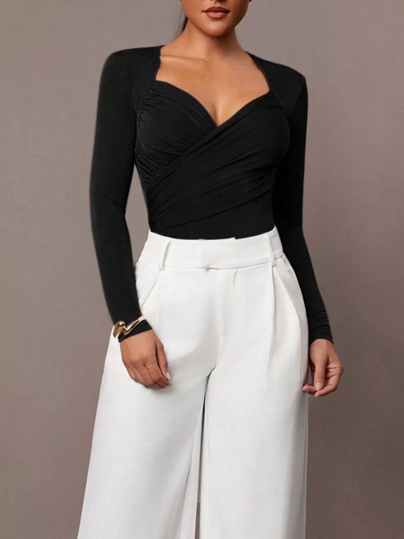 Black ruched surplice long sleeve bodysuit worn with white wide leg trousers, full front view