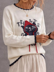 Side view of beige cat sweater with black cat and red strings
