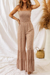 Women's floral smocked jumpsuit with spaghetti straps and wide legs.