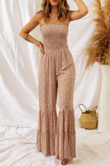 Women's floral smocked jumpsuit with spaghetti straps and wide legs.
