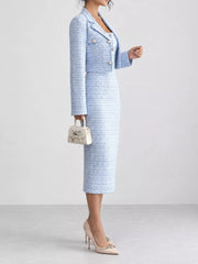 Side view of light blue tweed dress and cropped cardigan with small handbag