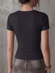 Back view of fitted black short-sleeve T-shirt with white speckled print on a model