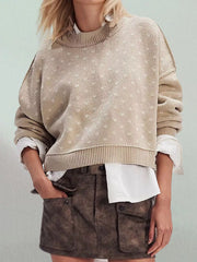 Front view of the khaki dotted sweater with ribbed hem and dropped shoulder seams on model