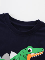 Close-up of the black round neckline and green dinosaur head graphic on a children's T-shirt