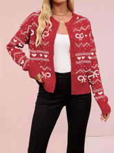 Open front view of red cardigan with white bow and heart pattern over a white top and black pants