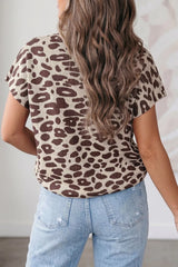 Back view of a brown leopard print knit top worn with light blue jeans.