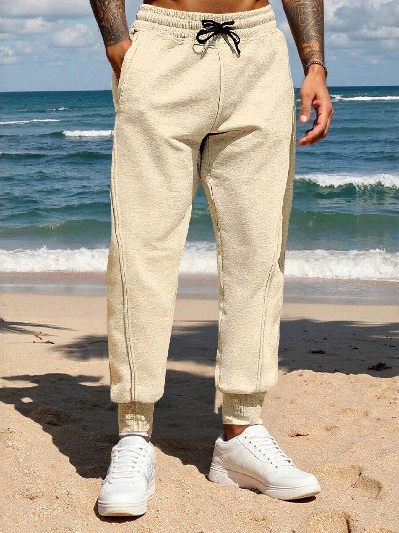 Men's khaki casual joggers with a drawstring waist and pockets.