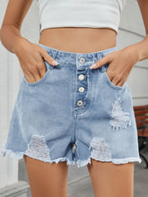 Women's distressed denim shorts with unfinished hems and a non-stretch fabric blend.