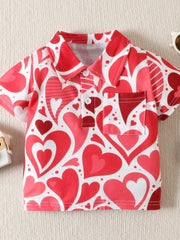 Flat front view of a red and white children's polo with large heart print collar and pocket