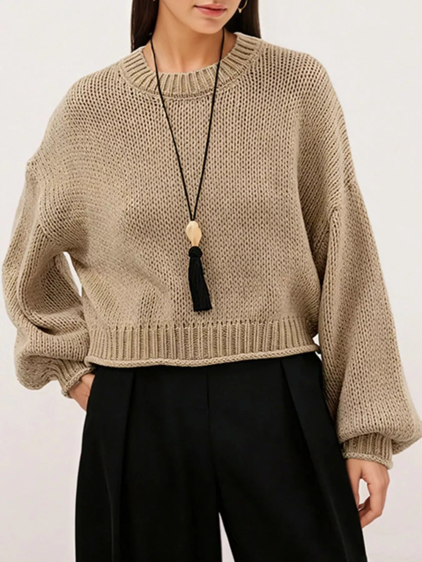 Close on-model front view of a khaki oversized chunky knit sweater with ribbed hem