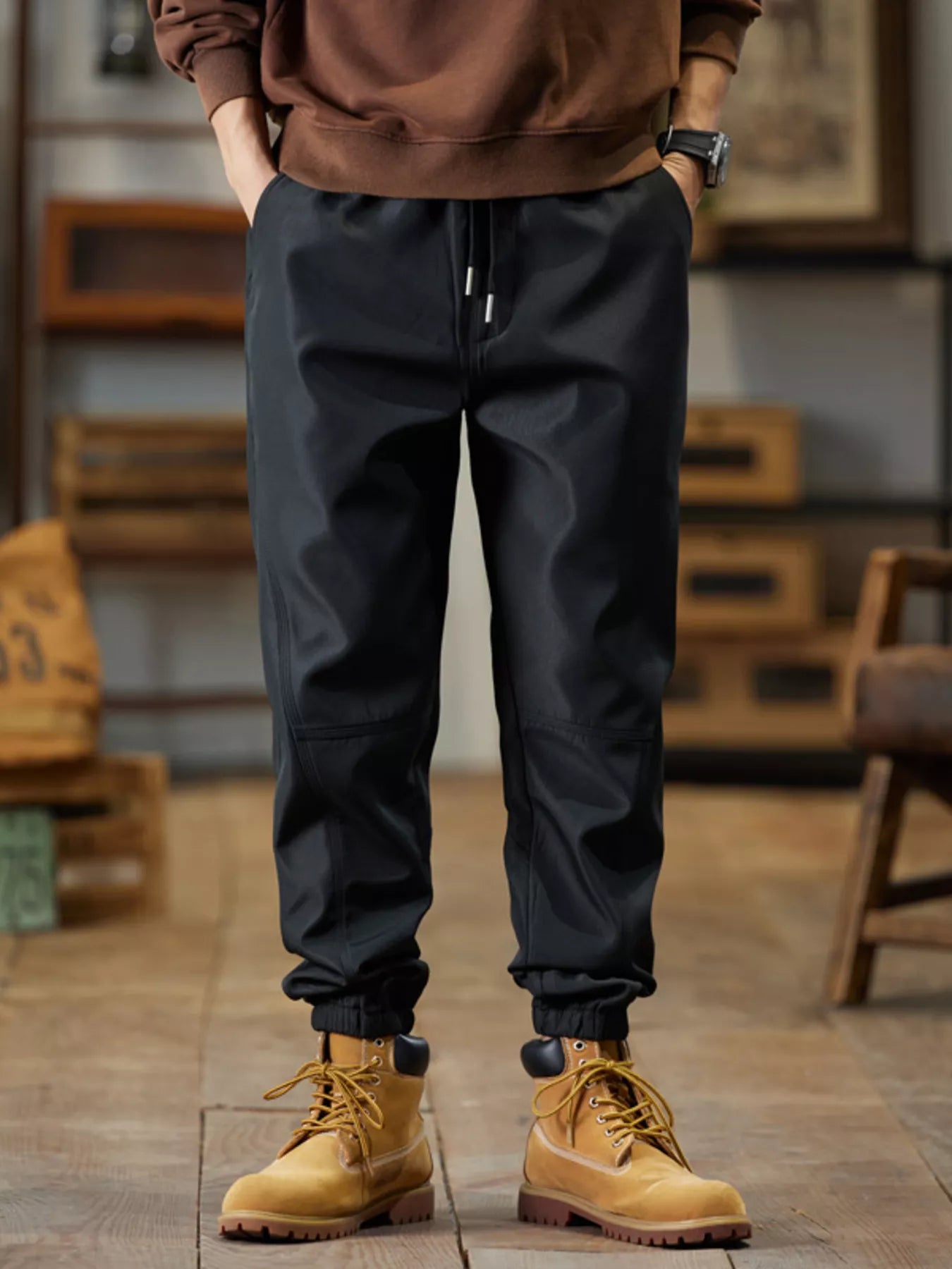 Men's black casual joggers with a drawstring waist and pockets.