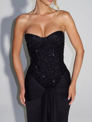Black strapless sequin corset bodice and draped waist, close front view on model