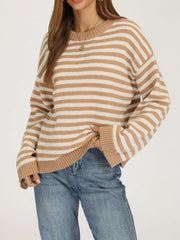 Front angled view of the khaki and white striped sweater with dropped shoulders and ribbed trim.