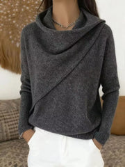 On-model front view of a dark gray cowl neck sweater with a draped asymmetric collar and long sleeves