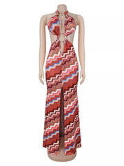 Rust chevron halter maxi dress with ring details and front slit on a mannequin