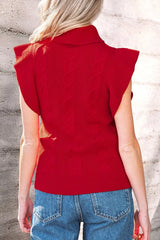 Outdoor back view of a red cable knit turtleneck sweater with ruffled short sleeves