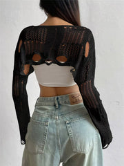 Back view of black distressed cropped knit cover up with openwork and cutouts.