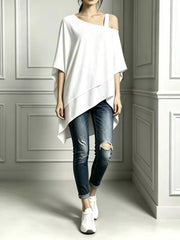 White asymmetrical-neck short-sleeve tunic top styled with distressed jeans and white sneakers, front view
