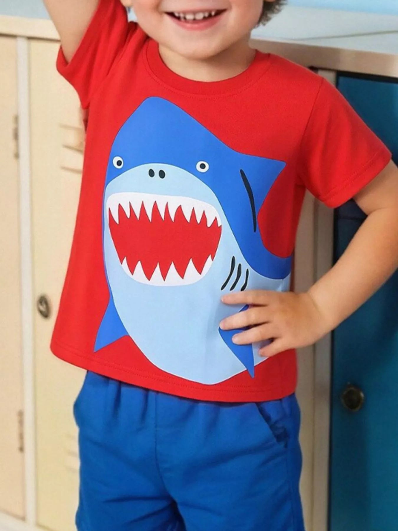 Children's red short-sleeve T-shirt featuring a shark graphic design.