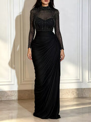 Black mock neck maxi dress with sheer rhinestone bodice and ruched skirt, front view