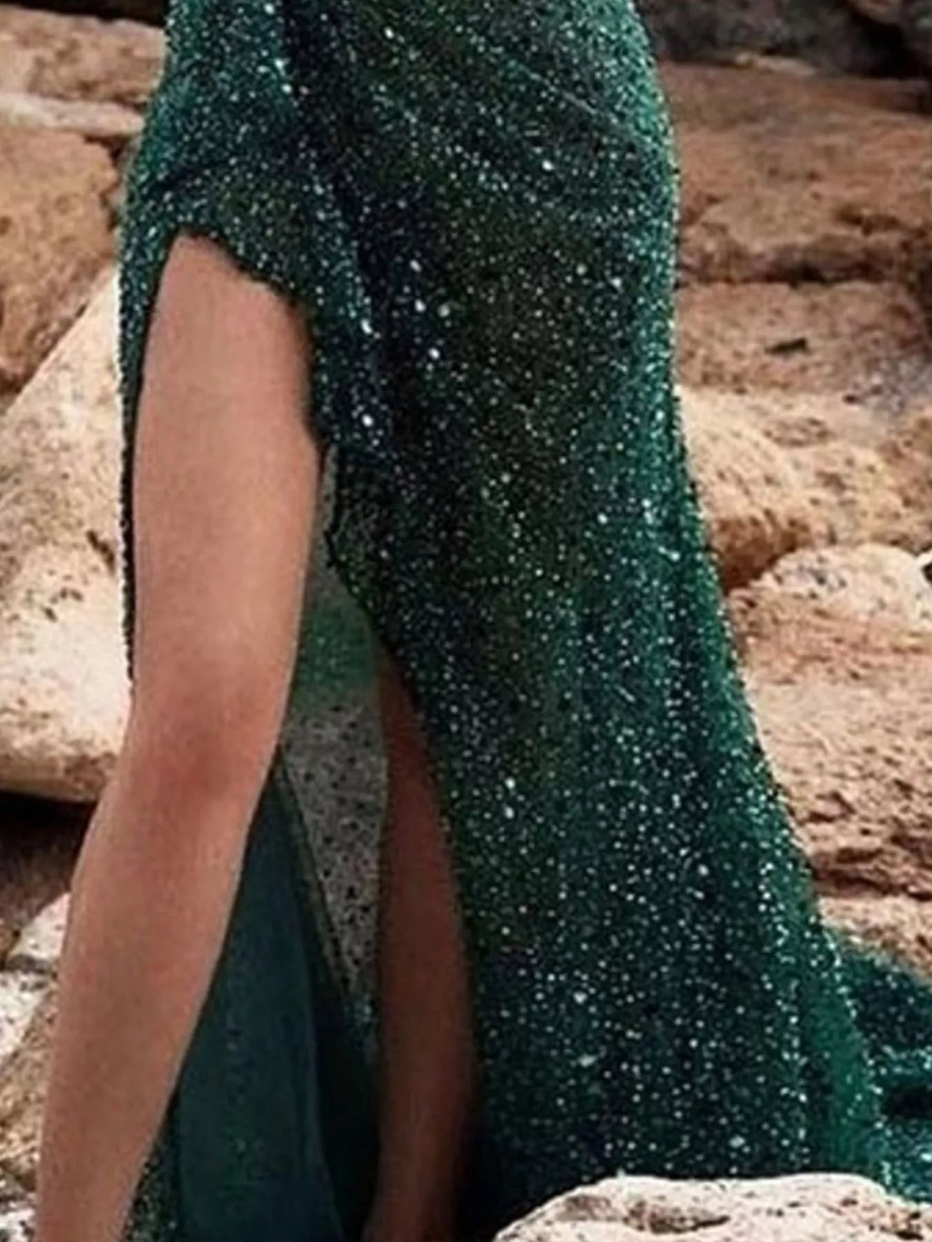 Close view of green plus size sequin evening dress skirt showing the high slit detail