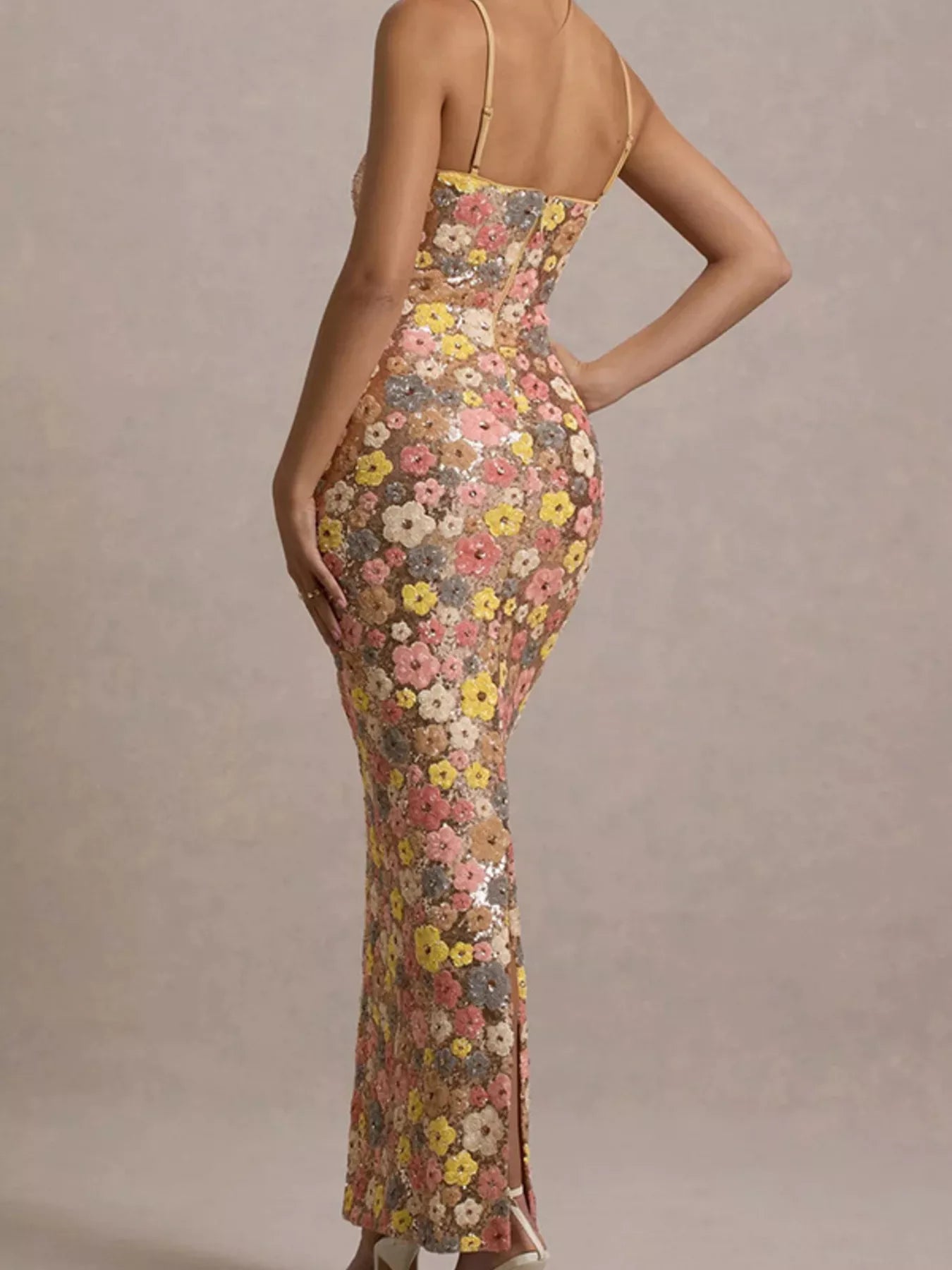 Back view of a multicolor floral sequin bodycon maxi dress showing the back zip and slit