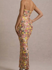 Back view of a multicolor floral sequin bodycon maxi dress showing the back zip and slit