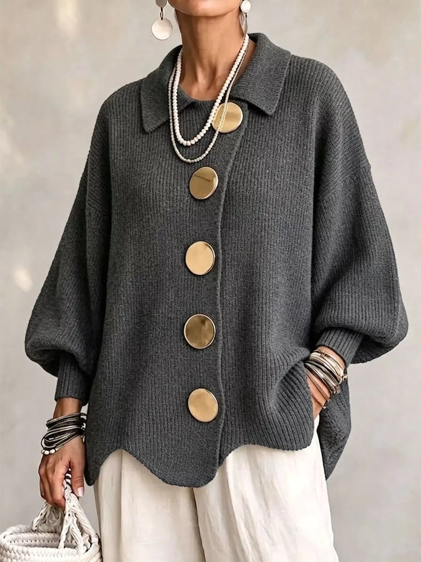 Front view of a dark gray knit cardigan with large gold buttons