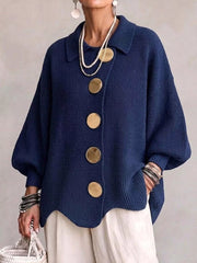 Front view of a navy knit cardigan with large gold buttons and lantern sleeves