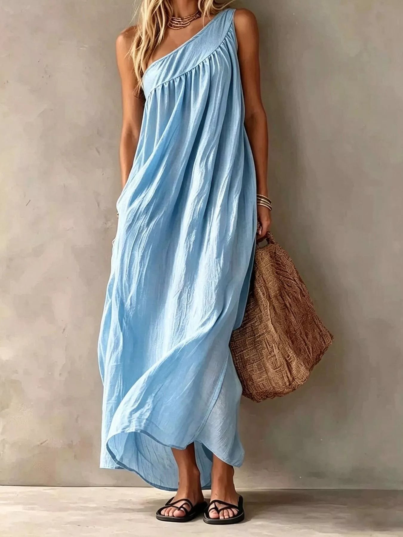 Full length front view of a light blue one shoulder maxi dress on a model