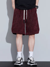 Men's loose fit shorts with a drawstring waist and pockets.