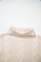 Close-up of the cream cable knit turtleneck sweater back neckline