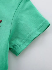 Close-up of the plain green short sleeve and double stitched hem on the children's T-shirt