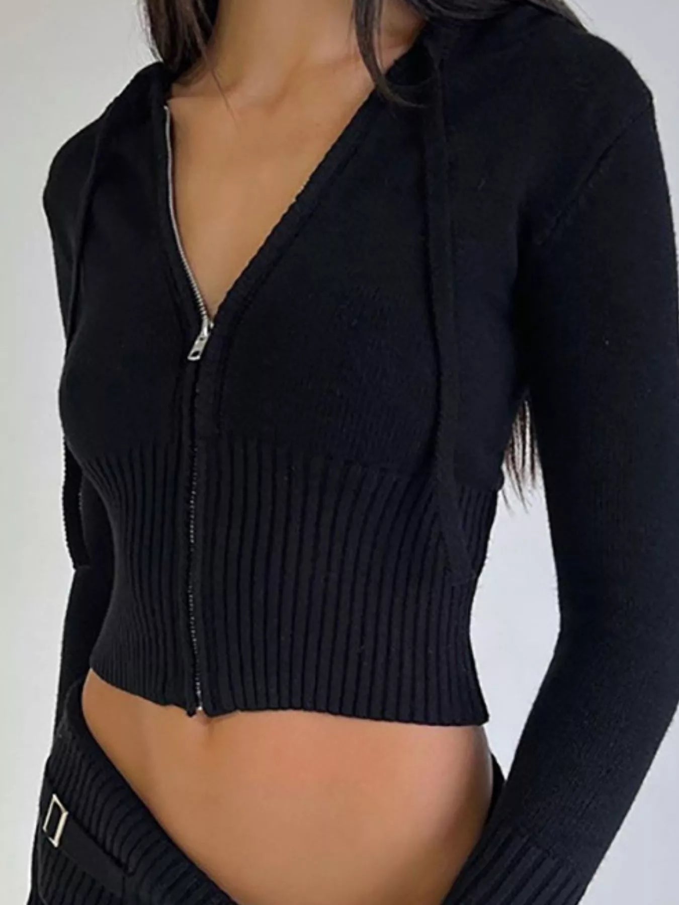 Close up front view of black ribbed zip up hooded knit cardigan