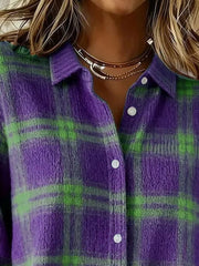 Close-up of the collar and button placket on a purple and green plaid knit cardigan