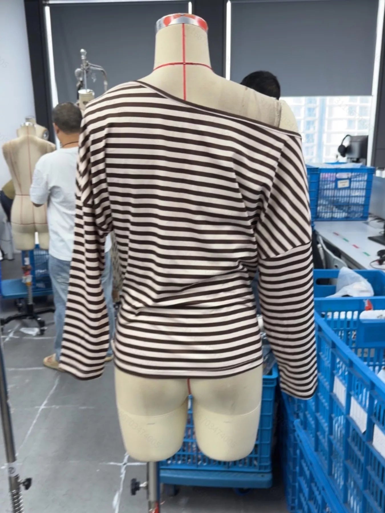 Back view of coffee brown and cream striped one shoulder long sleeve top on mannequin indoors