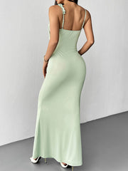 Back view of a light green floral bodycon mermaid maxi dress showing thin back straps