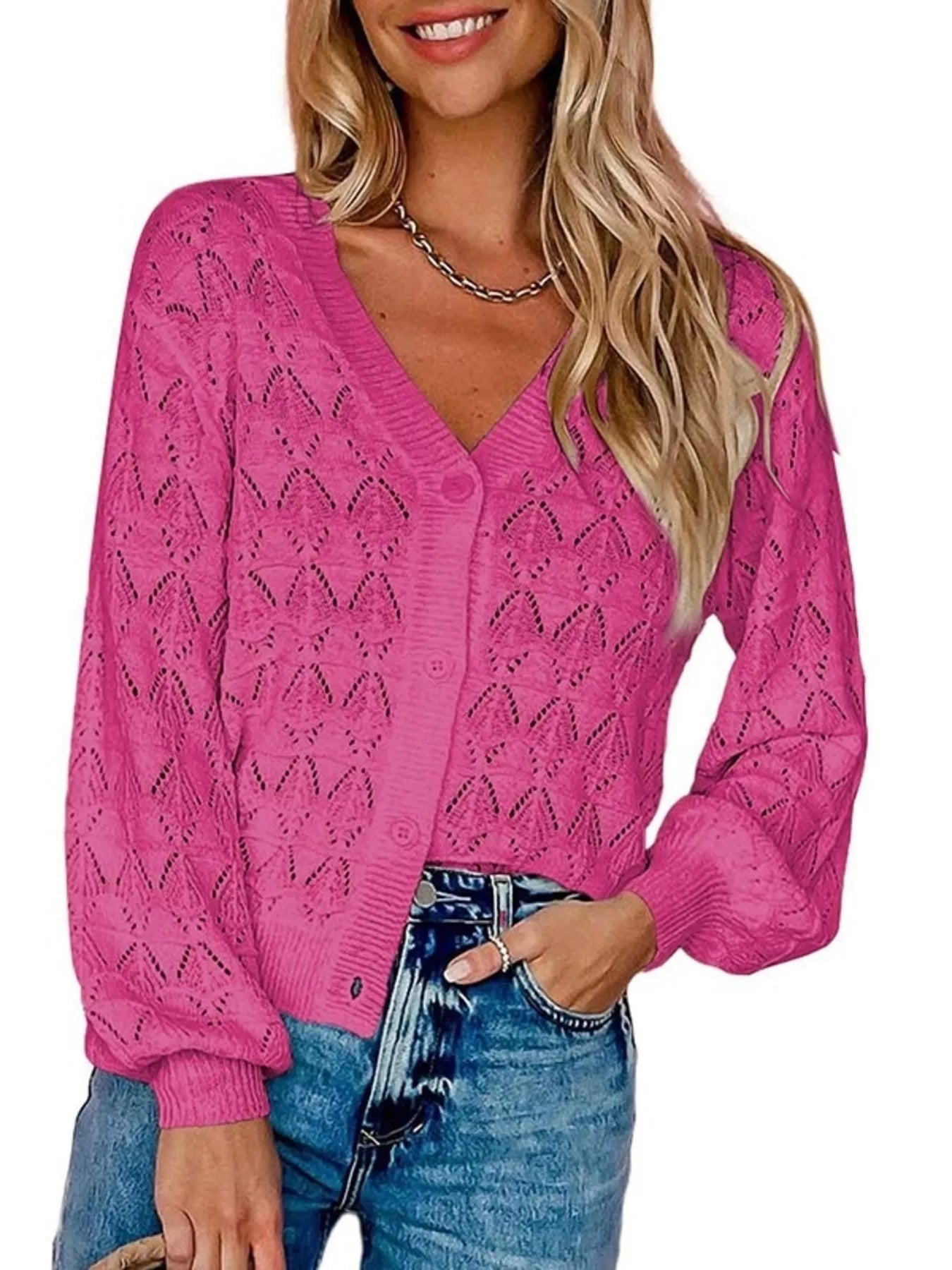 Front view of bright pink openwork leaf knit cardigan with V neck and button front.