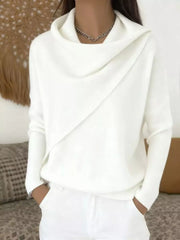 On-model front view of a white cowl neck sweater with a draped asymmetric collar and long sleeves