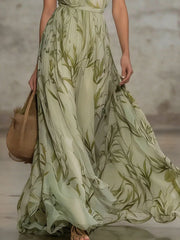 Lower view of a matcha leaf print chiffon maxi dress showing the flowing skirt in motion