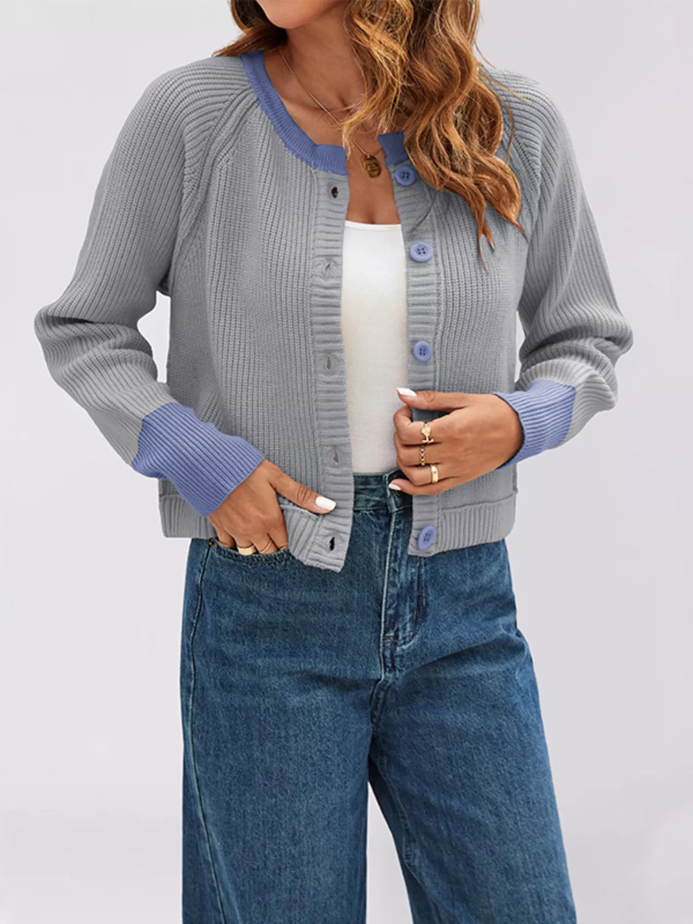 On-model front view of a gray ribbed cardigan with periwinkle trim worn over a white top