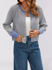 On-model front view of a gray ribbed cardigan with periwinkle trim worn over a white top