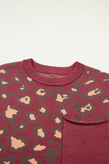 Close-up of the deep red leopard print knit top neckline and chest pocket