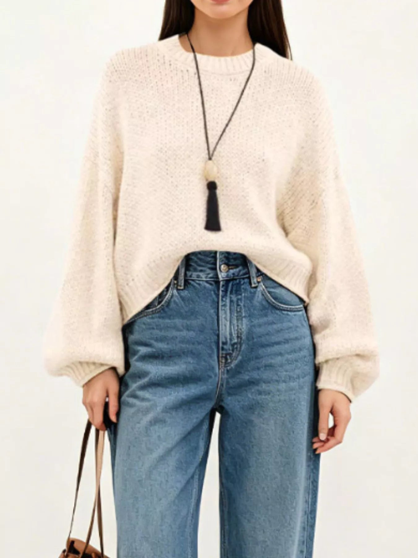 On-model front view of a cream oversized chunky knit sweater with balloon sleeves