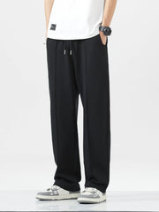 Men's wide-leg sweatpants with a drawstring waist and pockets in the black color.