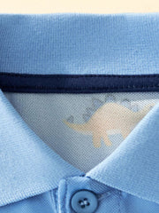 Close-up of the polo collar, inner navy trim, and top button on sky blue fabric